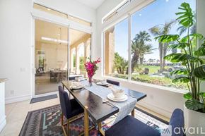 La Quinta house for rent - A dining room with a table set for two and a view of a backyard.