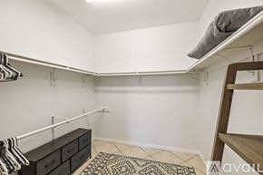 Indio house for rent - A bedroom with a bunk bed and a dresser with clothes hanging on it.