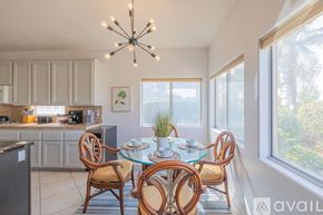 Indio house for rent - A dining room with a glass table and chairs.