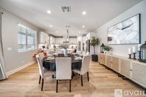 La Quinta house for rent - A modern dining room with a large table set for six.