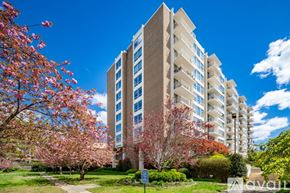 Washington apartment for rent - A tall building with a blue sign in front of it.