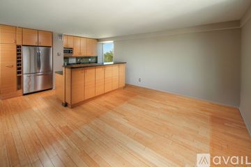 Washington apartment for rent - A kitchen with wooden cabinets and a refrigerator.