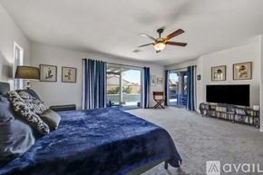 La Quinta house for rent - A bedroom with a large bed and a television.