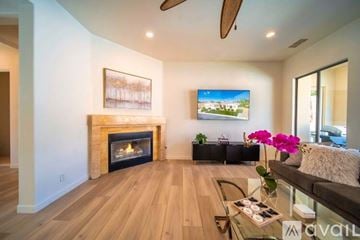La Quinta house for rent - A living room with a fireplace and a painting on the wall.
