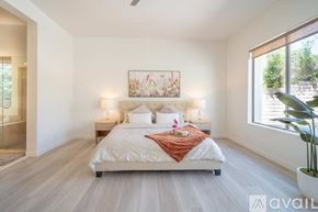 La Quinta house for rent - A bedroom with a large bed and a painting on the wall.