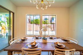 La Quinta house for rent - A dining room with a wooden table set for a meal.