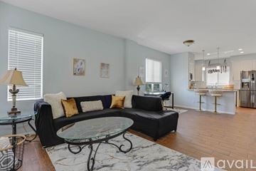 San Diego townhouse for rent - A living room with a black couch and a glass coffee table.