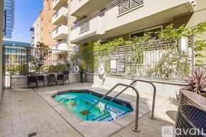 San Diego condo for rent - A small pool in a courtyard surrounded by a metal fence.
