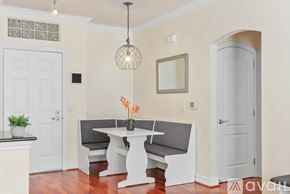San Diego condo for rent - A dining area with a white table and grey bench.