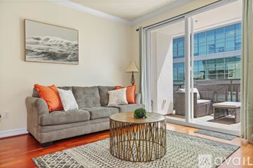 San Diego condo for rent - A living room with a grey couch and a wooden coffee table.
