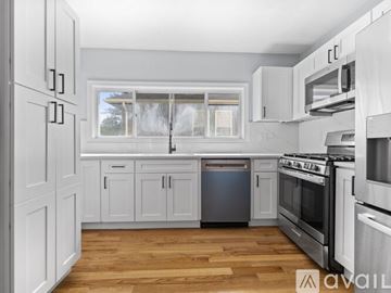 Medford apartment for rent - A kitchen with white cabinets and stainless steel appliances.