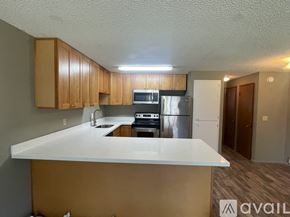 Lynnwood apartment for rent - A kitchen with a white countertop and wooden cabinets.