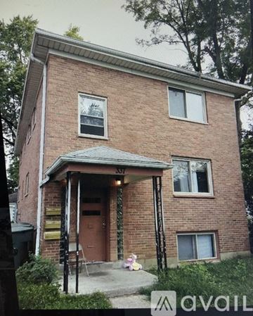 Dayton apartment for rent - A brick house with a porch and a mailbox on the front door.