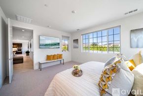La Quinta house for rent - A bedroom with a large bed and a view of the outdoors through the window.