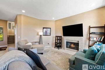 La Quinta house for rent - A living room with a fireplace and a television on the wall.
