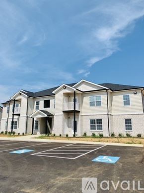 Bowling Green apartment for rent - A large two-story building with a parking lot in front.