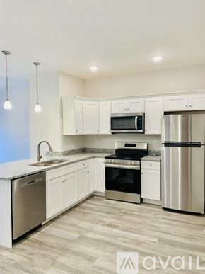 Bowling Green apartment for rent - A kitchen with white cabinets and stainless steel appliances.