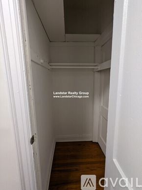 Chicago apartment for rent - A small, empty room with wood flooring and white walls.