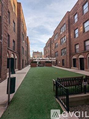 Chicago apartment for rent - A long, narrow courtyard between two brick buildings.