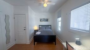 San Diego apartment for rent - A bedroom with a bed, nightstand, and a ceiling fan.