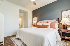Willow Park townhouse for rent - A bedroom with a large bed and a ceiling fan.