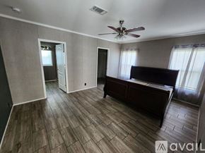 Stilwell apartment for rent - A room with a ceiling fan and a bed.