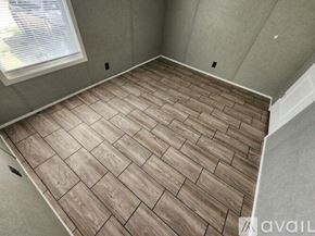 Stilwell apartment for rent - A room with a wooden floor and a window.