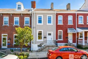 Pittsburgh house for rent - A row of houses with a red car parked in front of them.