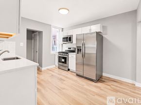 Pittsburgh house for rent - A white door is next to a white sink in a bathroom.