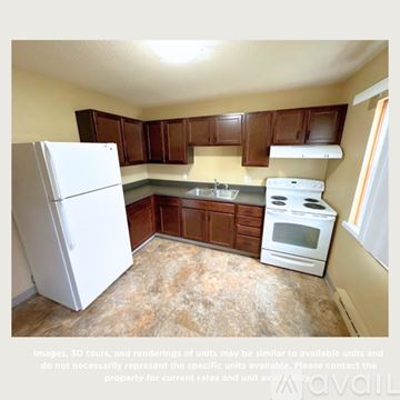 Spencer apartment for rent - A kitchen with brown cabinets and a white refrigerator.