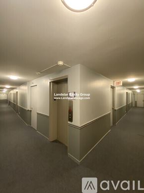 Chicago apartment for rent - A long hallway with Landstar Realty Group signage.