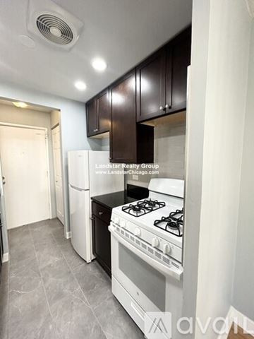 Chicago apartment for rent - A kitchen with a stove top oven and a refrigerator.