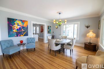 St. Petersburg house for rent - A living room with a blue chair and a painting on the wall.