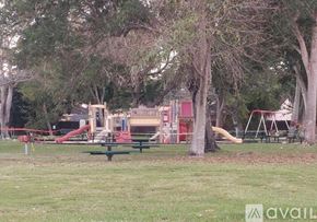 Hialeah apartment for rent - A playground with a red slide and a green picnic table.