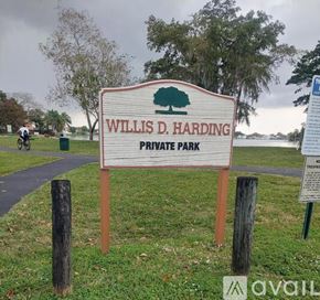 Hialeah apartment for rent - A park with a paved path and trees.