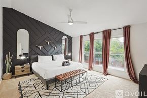 North Richland Hills house for rent - A bedroom with a large bed and a ceiling fan.