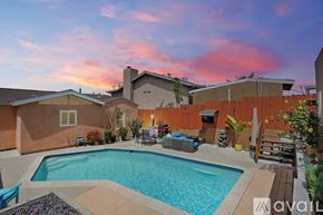 San Diego house for rent - A backyard with a pool and patio furniture.