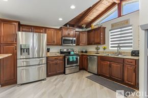 San Diego house for rent - A kitchen with wooden cabinets and stainless steel appliances.