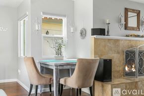 San Diego house for rent - A dining room with a table, chairs and a fireplace.