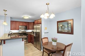 San Diego condo for rent - A kitchen with a table and chairs in the middle of the room.