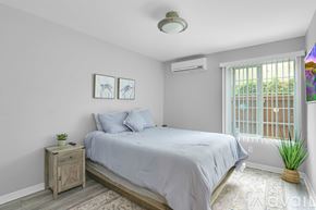 San Diego condo for rent - A bedroom with a bed, nightstand, and window.