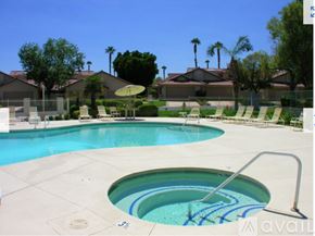Palm Desert house for rent - A pool with a slide and a hot tub in the middle.