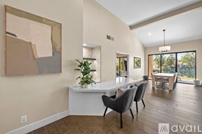 La Quinta house for rent - A modern dining room with a white table and chairs.
