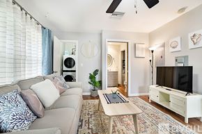 West Palm Beach apartment for rent - A living room with a couch, a coffee table, and a television.