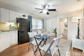 West Palm Beach apartment for rent - A kitchen with a black refrigerator and white cabinets.