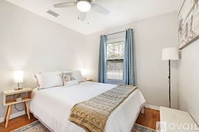 West Palm Beach apartment for rent - A bedroom with a large bed and a ceiling fan.