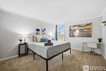 San Diego condo for rent - A living room with a grey couch and a painting on the wall.