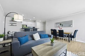 San Diego condo for rent - A kitchen with white cabinets and a black bar stool.
