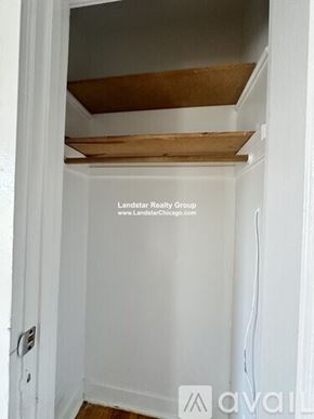 Chicago apartment for rent - A white closet with a wooden shelf above it.