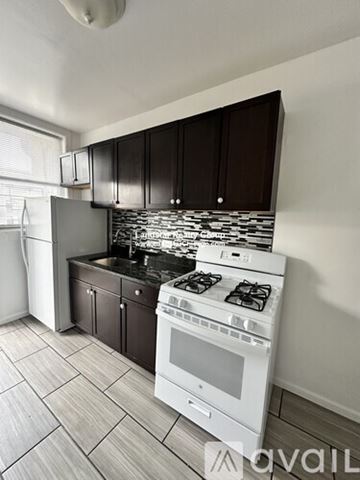 Chicago apartment for rent - A kitchen with a white stove top oven and a white dishwasher.